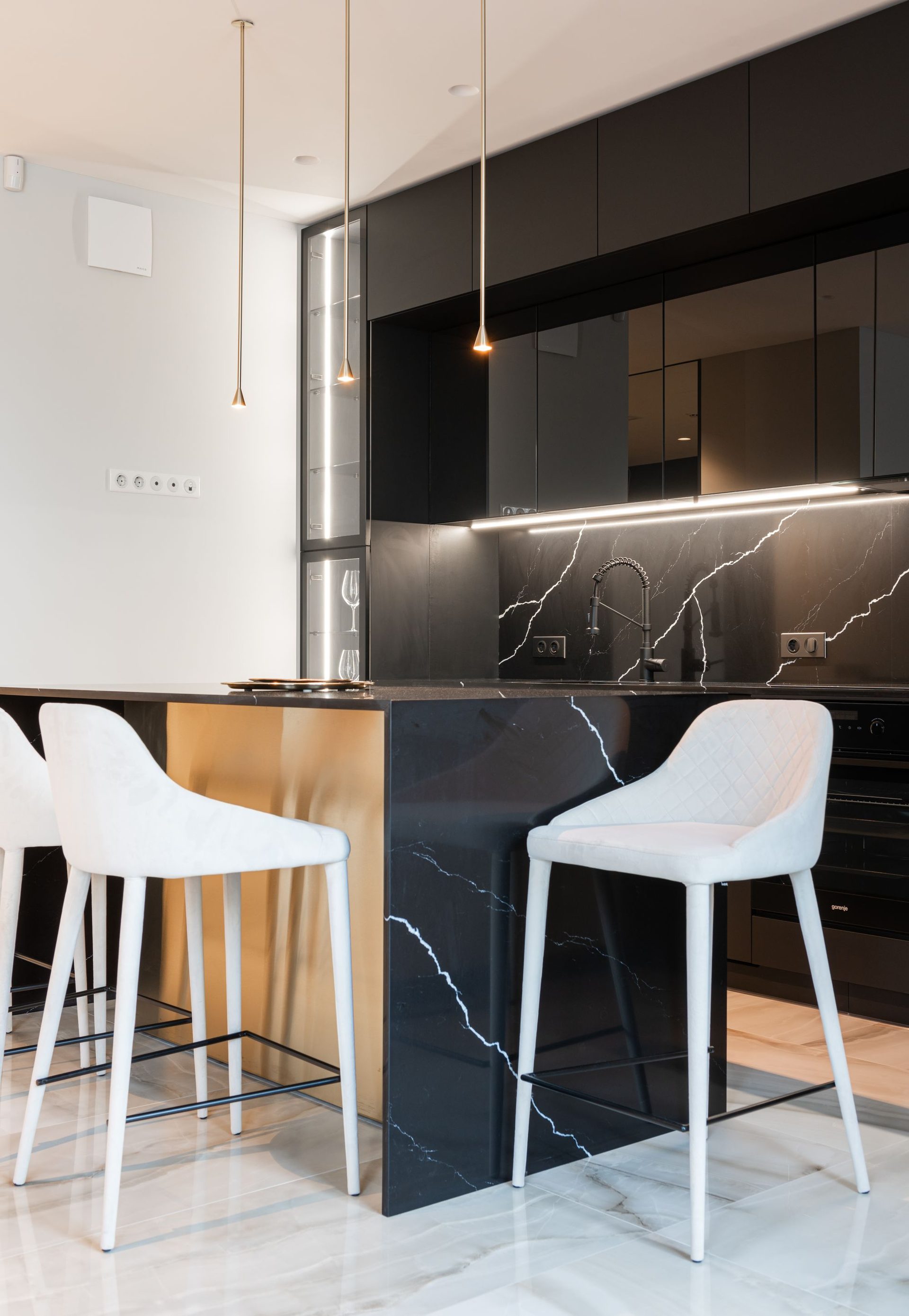 Black marble bar with bar stools and concealed lighting