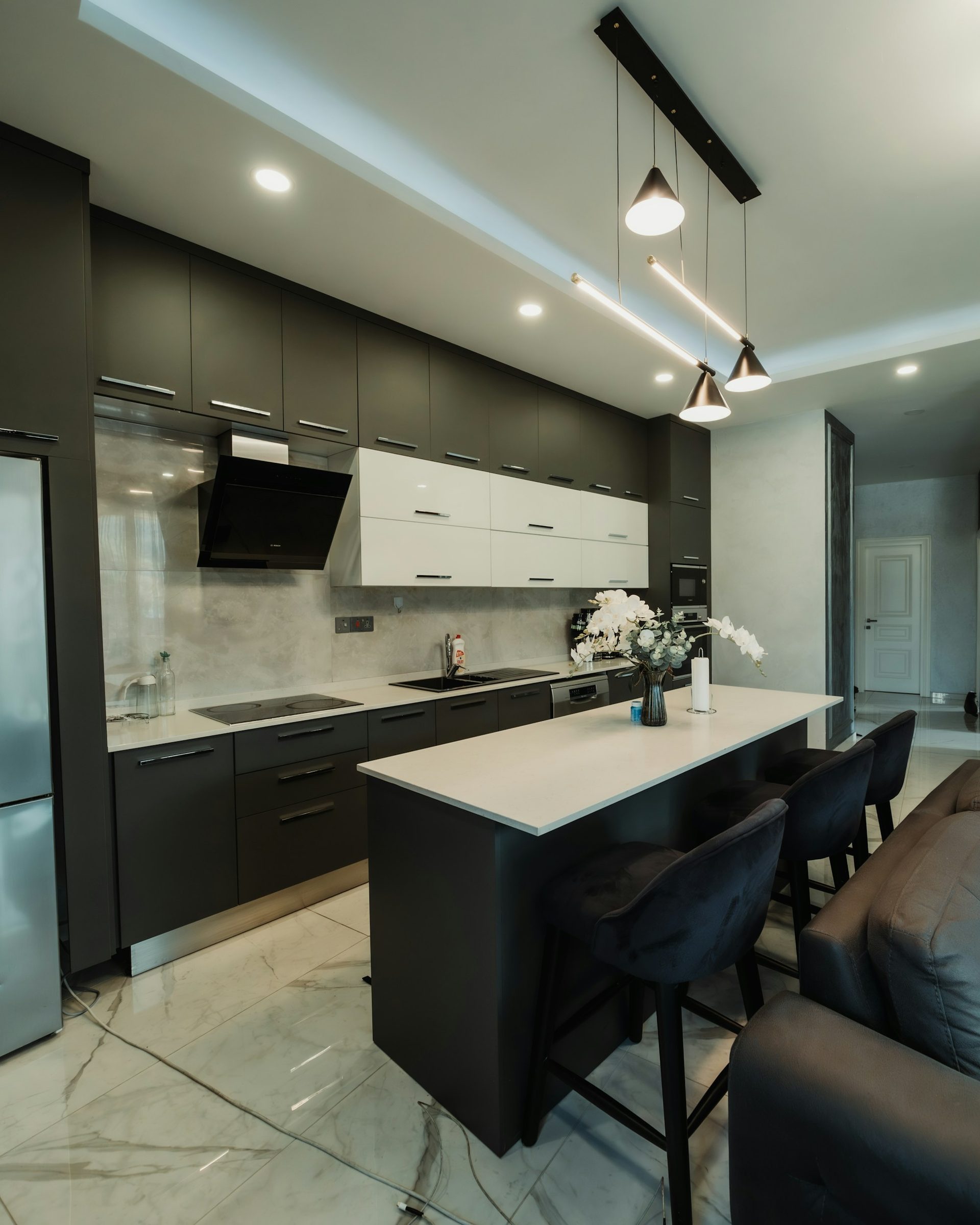 Dark cabinetry kitchen with a long island, delivered assembled ready to fit
