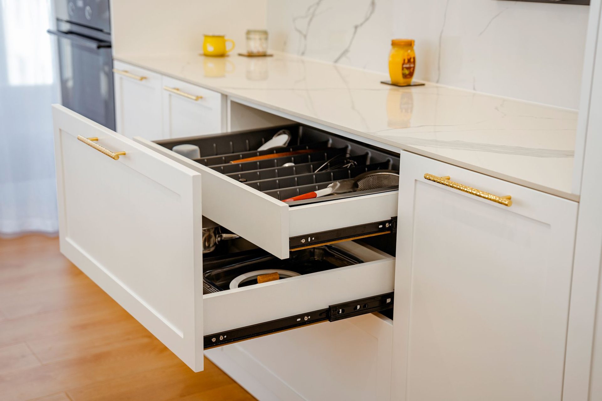 Deep pot drawers with brass handles and internal organisers