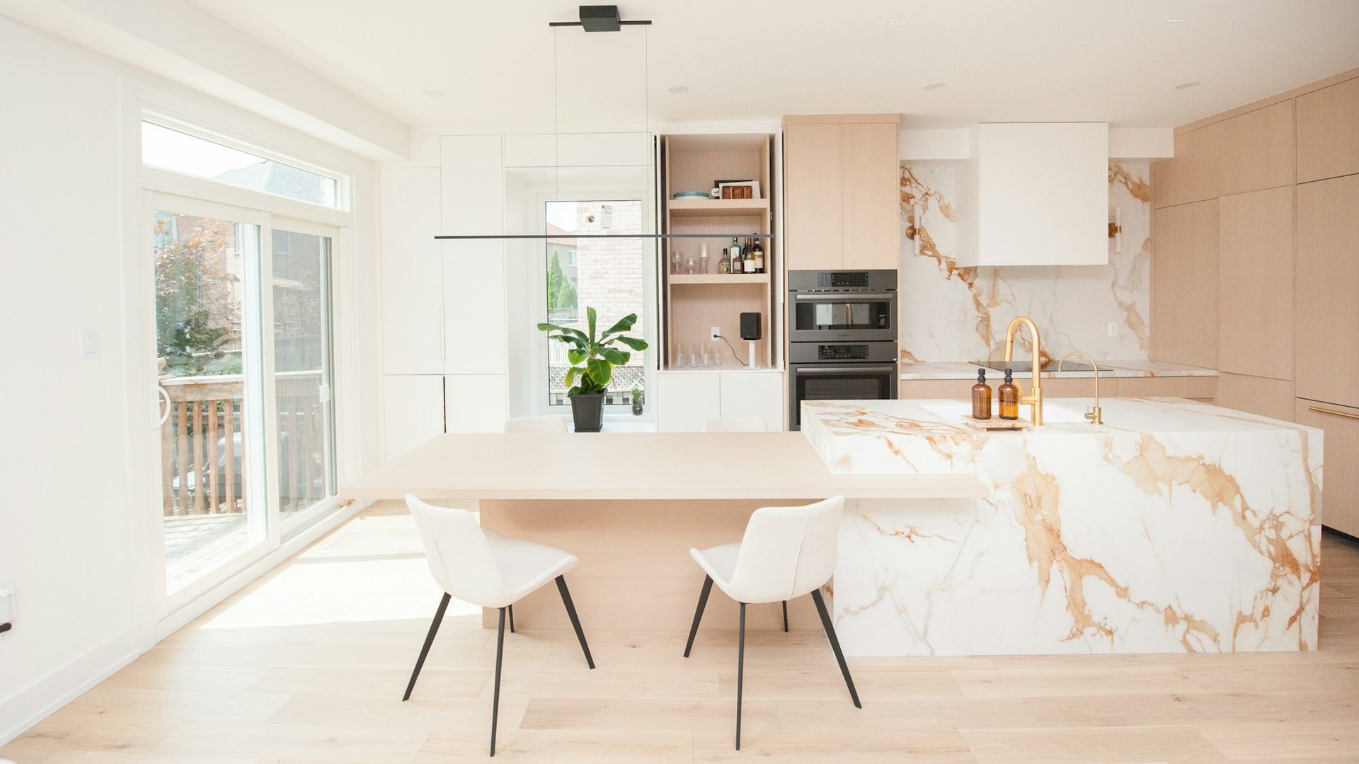 Calacatta marble waterfall island in a bright open kitchen