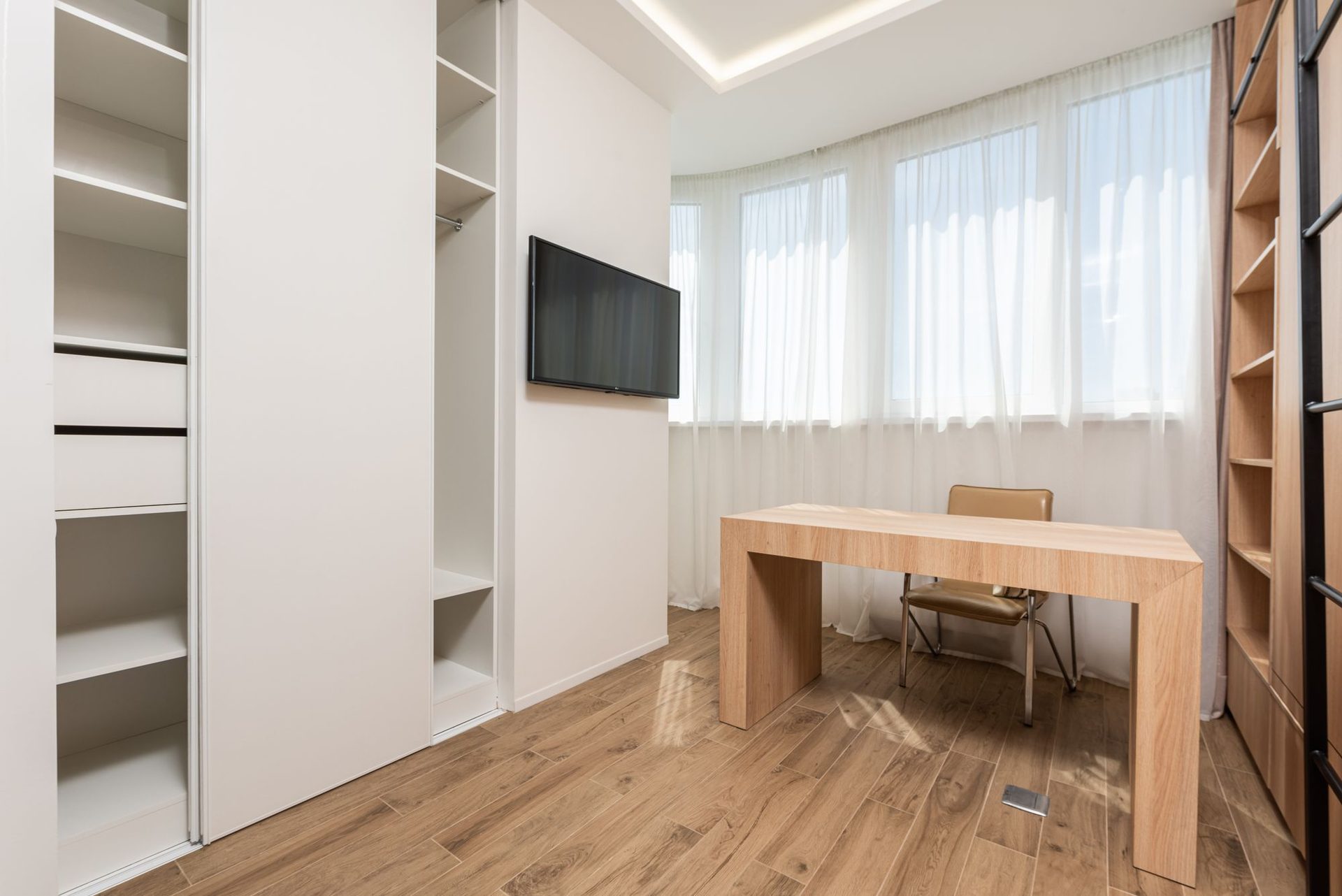 Built-in media wall and study joinery with integrated desk and shelving