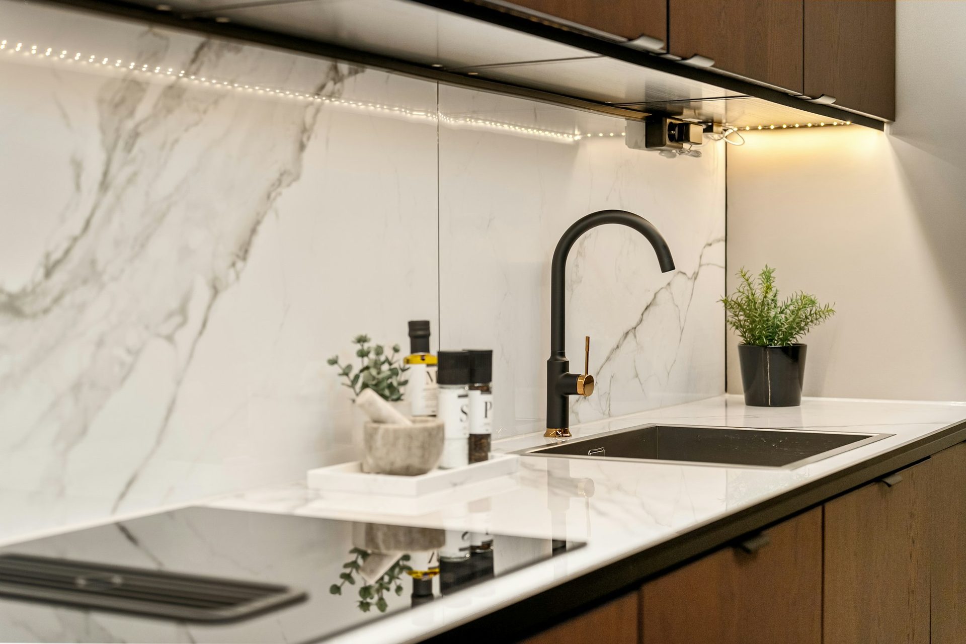 Full height marble splashback with matte black tapware