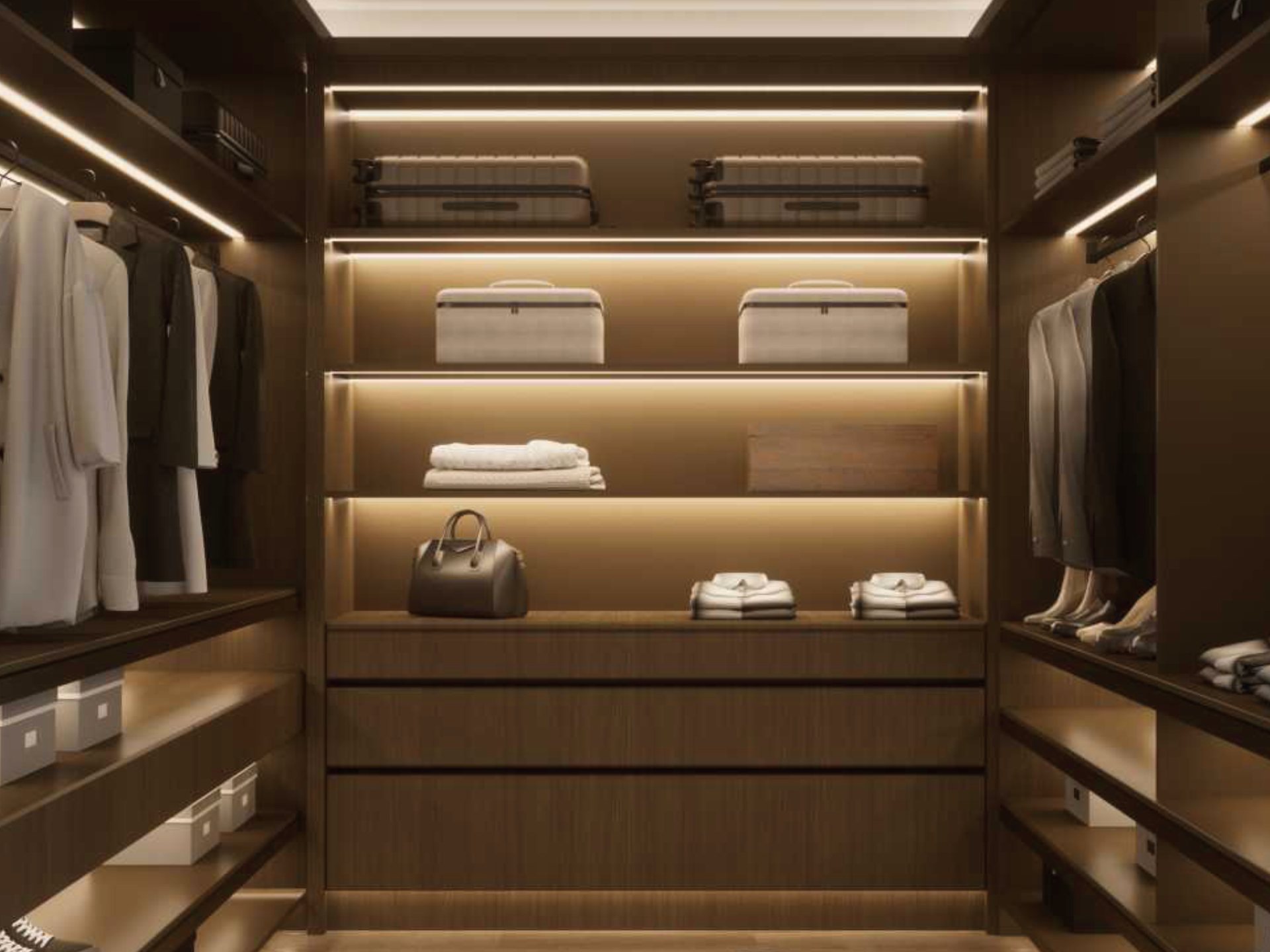 Walk-in wardrobe with lit shelving, hanging space and drawers